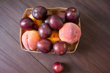 Fresh fruits. Healthy food. Mixed fruits, peaches and plums. Studio photography of various fruits on an old wooden table. Organic healthy assorted fruits. Assortment of fresh fruits. Fruit food backgr