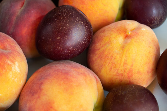 Fresh fruits. Healthy food. Mixed fruits, peaches and plums. Organic healthy assorted fruits. Assortment of fresh fruits. Fruit food background.