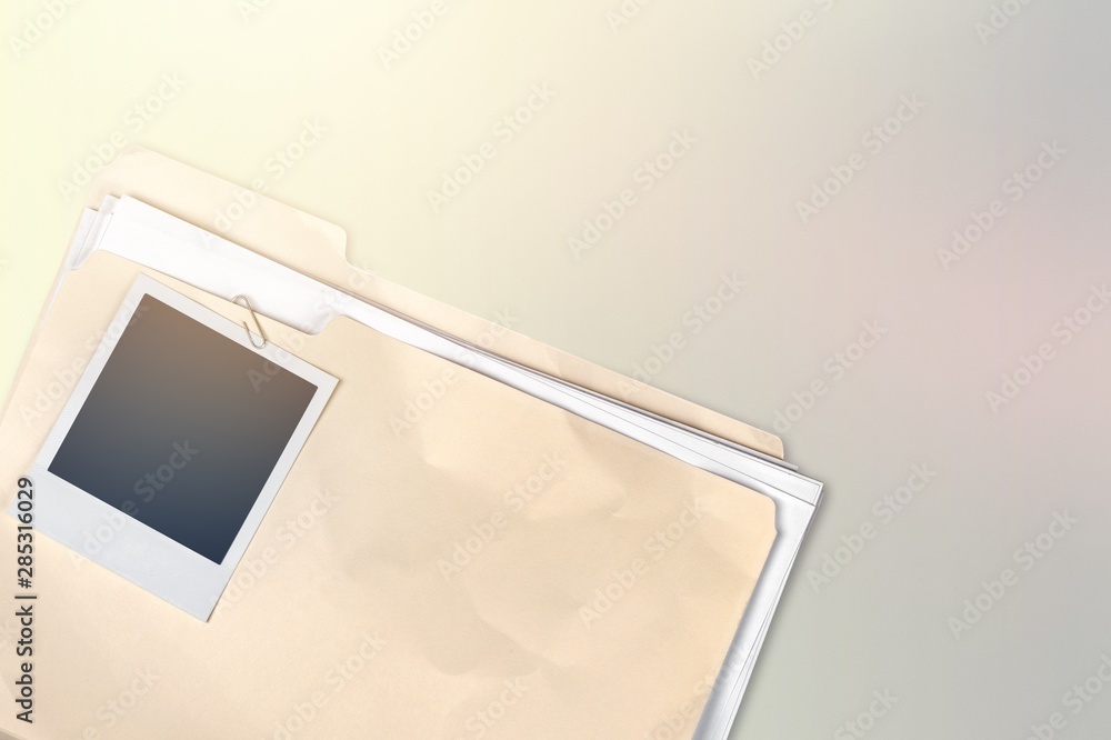 Poster file folder with documents and blank polaroid