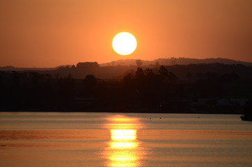  Late afternoon at the dam with the sun and its reflection in the water