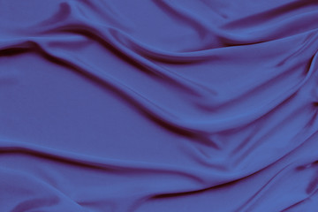 lilac beautiful satin draped with soft folds fabric, silk cloth background, close-up, copy space