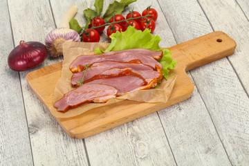 Sliced smoked duck breast served salad
