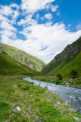 Fototapeta na wymiar Mountain region landscape in Kazbegi, Georgia - Dramatic landscape of popular adventure trekking and hiking region in the Caucasus. 