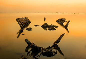 silhouette of boat on lake at sunset