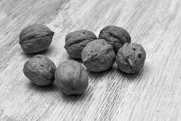 Whole walnuts on cream colored wood, healthy food