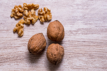 Whole walnuts on cream colored wood, healthy food
