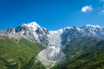 Fototapeta na wymiar Svaneti landscape with glacier and snow-capped mountain in the back near Mestia village in Svaneti region, Georgia.