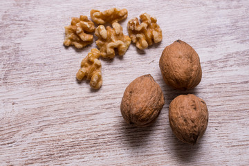 Whole walnuts on cream colored wood, healthy food