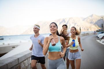 Happy people jogging outdoor. Running, sport, exercising and healthy lifestyle concept