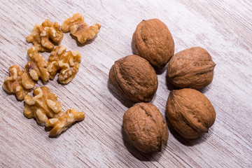 Whole walnuts on cream colored wood, healthy food