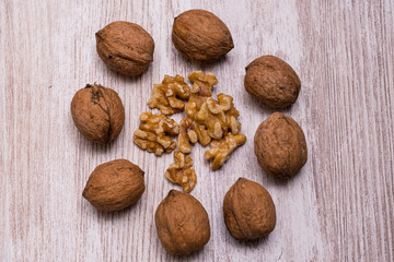 Whole walnuts on cream colored wood, healthy food