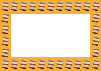 Frame with chocolate cakes on an orange background
