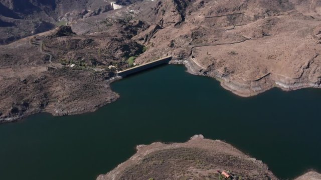 Aerial view of the "Las Ni&ntilde;as Dam" (East-West Direction with panning) located in the municipality of Tejeda, south of the Canary Island of Gran Canaria (Spain, Europe).