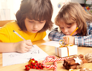 two Boys write a letter to Santa Claus. Near christmas tree. Merry Christmas and Happy Holidays