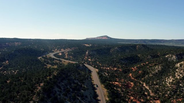 Drone aerial view of cars driving down a beautiful back country road in Arizona, USA