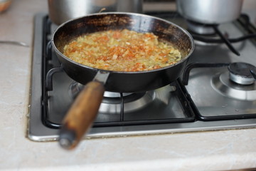roasting in a frying pan on a stove