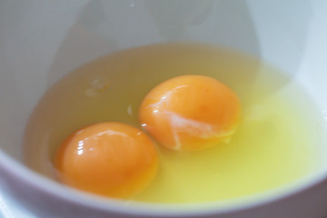 Closeup fresh raw eggs on white background.