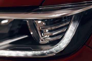 Closeup headlights of a modern car. Detail on the front light of a car. Modern and expensive car concept