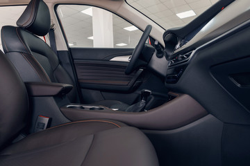 Leather car interior. Modern car illuminated dashboard. Luxurious car instrument cluster. Close up...