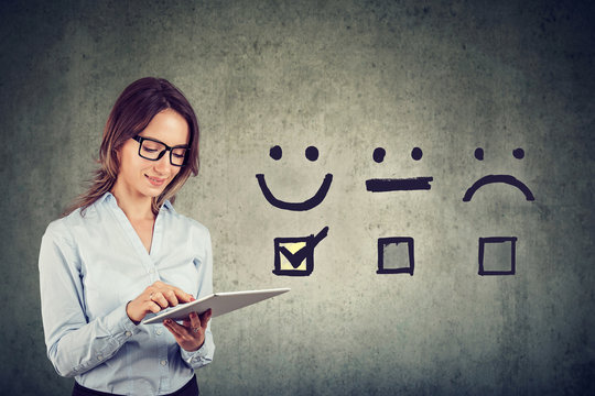 Happy business woman giving excellent rating for online satisfaction survey