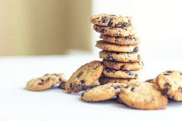 stack of chocolate chip cookies on white background