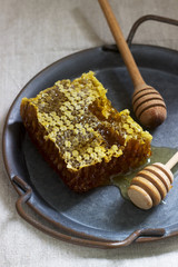 Honey comb on a tin tray on linen tablecloths. Rustic style.