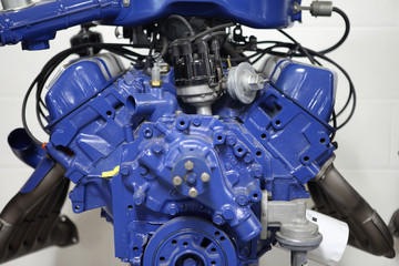 An American V8 combustion engine on display at an automotive shop.