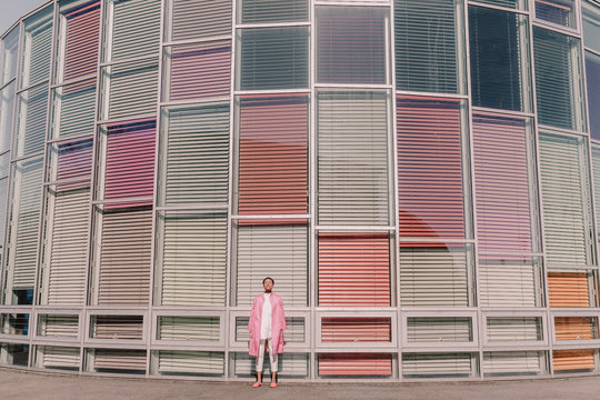 Young woman posing in front of modern building