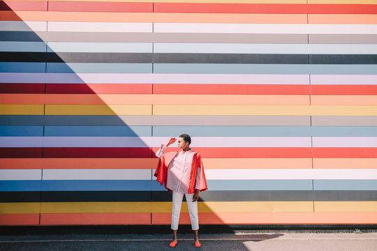 Girl with colorful striped building