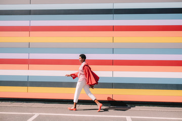 Girl with colorful striped building