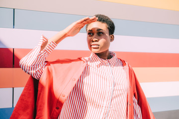 Girl with colorful striped building