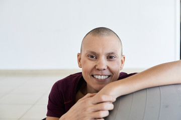 Portrait of cheerful woman fighting cancer.