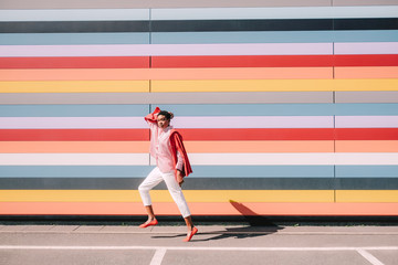 Girl with colorful striped building