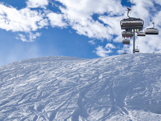 Fototapeta premium France, Meribel valley: Panoramic landscape view down valley with ski slope piste in winter alpine mountain resort