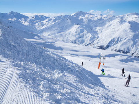 France, Meribel valley: Panoramic landscape view down valley with ski slope piste in winter alpine mountain resort