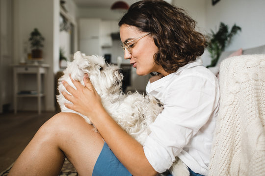 Girl sitting on a floor with her dog