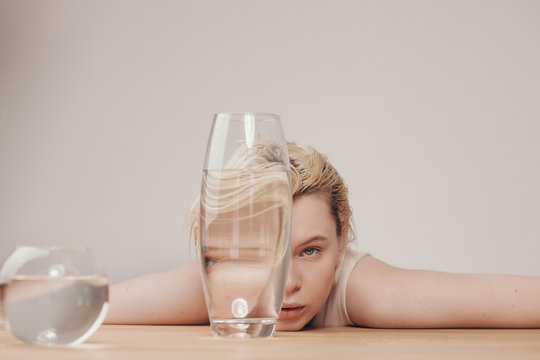 Portrait of young model through shaped glassware