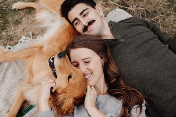 Couple Cuddling with Dog