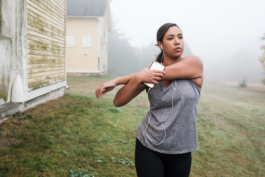 Beautiful Mixed Race Woman Stretching Before Exercising