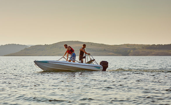 men on a motor boat preparing for jet ski