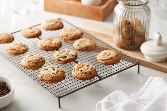 Baked cookies with chocolate chips on metal sheet.