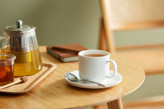 Delicious herbal tea in cup on saucer.