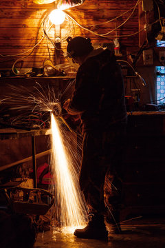 Craftsman using angle grinder