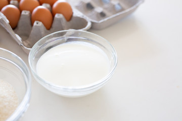 Fototapeta na wymiar Baking Ingredients with Brown Eggs in Carton