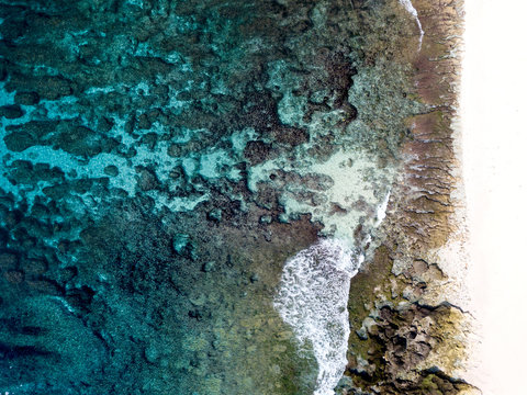 Aerial views of turquoise waters and a sandy beach