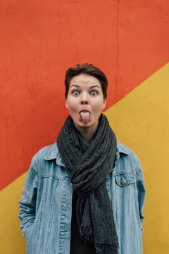 Stylish woman showing tongue