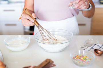 woman whisking flour in kitchen