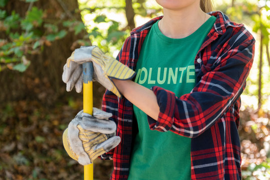 Volunteer leaning on tool