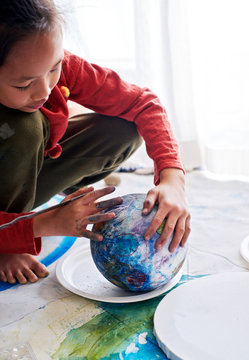 Asian children make artistic paintings at home