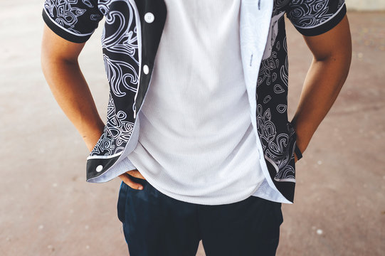 Young hispanic break dancer performing a dance in the street at sunset